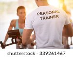 Personal trainer on weights lifting training with  client