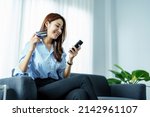 Small photo of Online Shopping and Internet Payments, Portrait of Asian woman are using their mobile phones and credit cards to shop online or conduct errands in the digital world.