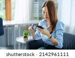 Small photo of Online Shopping and Internet Payments, Portrait of Asian woman are using their credit cards and to smart mobile phones shop online or conduct errands in the digital world.