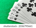 Small photo of Combinations of cards in poker, straight flush five cards of black cross suit from six to ten, selective focus