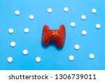 Small photo of 3D anatomical model of liver is on blue background surrounded by white pills as ornament polka dots. Medical concept by pharmacological tableted treating of liver disease, pharmacotherapy chemotherapy