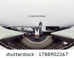 Small photo of The word ghostwriter typed on the paper with a vintage typewriter. Close up flat lay view