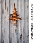 Small photo of Outdoor Copper Electric Wall Sconce with Etched Seedy Glass on galvanized steel plate wall.