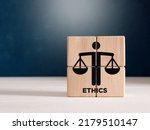 Small photo of Business ethics or justice symbol on wooden cubes. Ethical corporate culture, business integrity and moral principles concept.