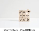 Small photo of PPC Pay Per Click concept. Internet marketing business concept. Wooden cubes with ppc symbols and text.