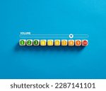 Indicator measuring volume level. High level of sound volume. Volume level numbers on wooden cubes with a volume meter on blue background.