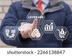 Small photo of Businessman using virtual touchscreen presses word: LEVERAGE. Leverage in dollars. Leverage investing. Investor borrow money or stock to increase potential return concept.