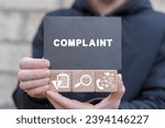 Small photo of Man holding wooden cubes with icons and black sticky note with word: COMPLAINT. Concept of complaints. Customer complaint, dissatisfaction from product or service problem, angry feedback from client.