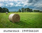 Hay Bale On A Green Meadow And...