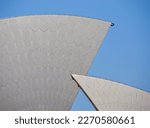 Closeup on the white tiled sails of the iconic opera house in Sydney against a clear blue sky