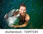 Girl Hugging A Dolphin In The...