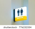 Restroom sign or toilet sign made of electric light box with man and woman icon set  symbol on white concrete wall background, modern, hygiene and clean restroom concept