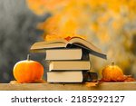 Books and pumpkins set in...