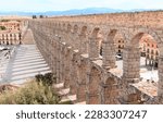 Small photo of Tourism at Segovia, Roman aqueduct on plaza del Azoguejo in Spain