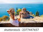 Small photo of Macedonia- travel, tour tourism,vacation- Woman in white dress and macedonian flag enjoying Ohrid lake