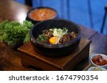 Dolsot bibimbap - Korean mixed rice, Include steamed rice, vegetables, pork and fried egg on top, served in a hot stone pot, Dolsot means stone pot in Korean.