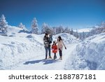 beautiful asian family walking together in landscape cover with wonderful snow