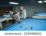 asian couple enjoy playing billiard together at billiard studio