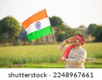 indian farmer saluting to national flag at agriculture field.