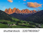 St. Magdalena village with magical Dolomites Odle mountain ridge in golden hour of sunset with alpenglow, Val di Funes valley, South Tyrol, Italian 