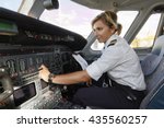Italy, female pilot in an airplane's cockpit