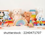 Educational kids toys collection. Teddy bear, wood plane, train, abacus, rainbow, wooden educational baby toys on white background. Sustainable, eco-friendly toys. Front view