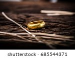 Golden ring on wooden background.