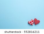 Plain blue background with two little, red heart