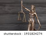 Small photo of The Statue of Justice - lady justice or justitia the Roman goddess of Justice. Statue on black wooden wall. Concept of judicial trial, courtroom process and lawyers occupation