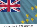 Small photo of Tuvalu flag with big folds waving close up under the studio light indoors. The official symbols and colors in fabric banner