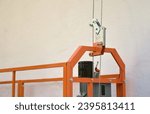 Small photo of Hoist supply and safety lock as part of suspended wire rope platform for facade works on high multistorey buildings. Hoist for elevation, raising or lifting cradle platform
