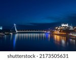 Small photo of Bratislava, Slovakia - May 31, 2022: Night view on Danube river, National Uprising bridge and Bratislava castle.