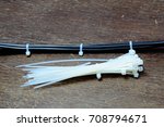 the electric wire and white  cable tie on wooden table