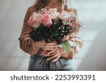Woman holding a beautiful bouquet with roses flowers. Front view. Valentine's, women's, mother's day. Autumn, summer concept