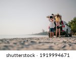 Family vacation holiday, Happy family running on the beach in the sunset.Parents holding their children.Concept family and Holiday and travel.