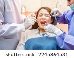 Small photo of Dentist examining teeth patients in clinic for better dental health and a bright smile.Dentist is extracting wisdom teeth.Dentist tools and equipment.