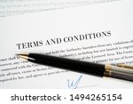 Small photo of Pen on the signature line on a terms and conditions agreement ready to be signed