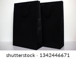 a pair of black paper bags on a ... | Shutterstock . vector #1342446671