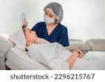 Professional specialist cosmetologist making mesotherapy with treatment facial skin care for fresh clean in beauty clinic. Beautiful Asian young woman with aesthetic face healthcare in a spa salon.