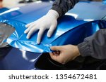 Car wrapping specialist putting ...