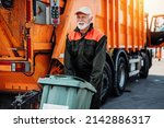 Small photo of Mature worker of the city utility company on his job. Garbage collector.