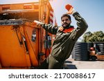 Small photo of Portrait of a young worker of the city utility company. Garbage collector.