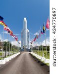 Small photo of KOUROU, FRENCH GUIANA - AUGUST 4, 2015: Model of Ariane 5 space rocket and flags of ESA members at Centre Spatial Guyanais (Guiana Space Centre) in Kourou, French Guiana