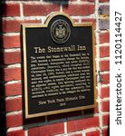 Small photo of Manhattan, New York - June 24, 2018: Metal plaque outside the Stonewall Inn bar, the day the 2018 New York City Pride Parade commemorates the 49th anniversary of the Stonewall Riots.