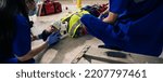Small photo of Employee accident in construction site work. Team EMS Paramedic first aid apply hard collar support builder neck and head injury from accident in site work. First aid procedure.
