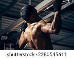 Small photo of Bodyweight workout. Athletic pulling up showing back muscle at gym. Muscular man exercise pull up on bar in fitness gym.