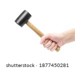 The hand holds a rubber mallet with a wooden handle. Сlose up. Isolated on a white background.