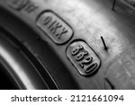 Dot code and date of production of the tire on the sidewall of the wheel. Close up. Tire shelf life.