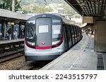 Small photo of KOWLOON TONG, HONG KONG - DEC 29, 2022: An MTR East Rail Line metro train approaching Kowloon Tong Station platform. This train is known as R-train made by Hyundai Rotem