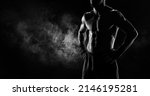 Small photo of Noname image of a kickboxer on a dark background. The concept of mixed martial arts. MMA